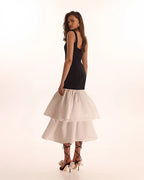 Black fitted maxi dress with white puffy tiered skirt Parisienne