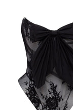 Black lace over the white mesh peplum corset with an oversized bow Parisienne