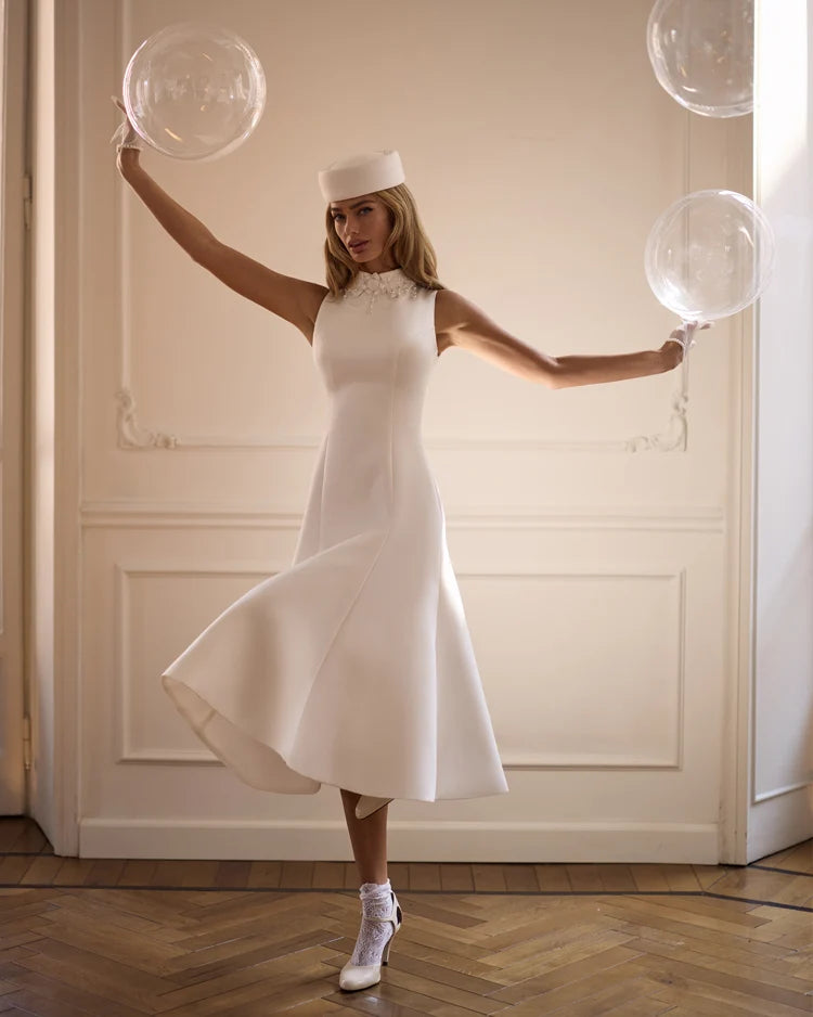 Elegant white midi dress with a high neckline