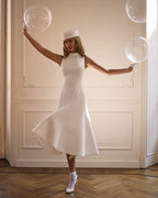 Elegant white midi dress with a high neckline
