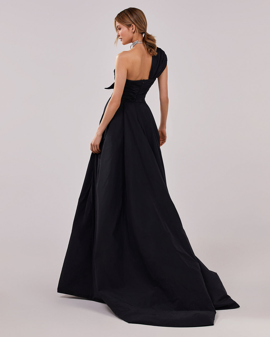 Black taffeta evening gown with a high slit and one shoulder wrap top