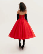 Dramatic red organza dress adorned with Millas signature and black gloves Xo Xo