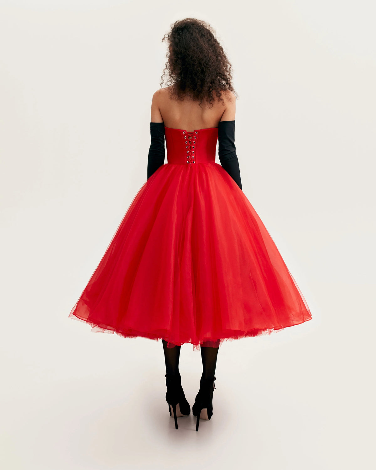 Dramatic red organza dress adorned with Millas signature and black gloves Xo Xo