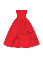 Dramatic red organza dress adorned with Millas signature and black gloves Xo Xo