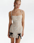 Fitted nude mini dress with bows