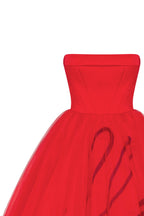Dramatic red organza dress adorned with Millas signature and black gloves Xo Xo