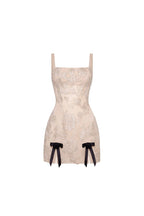 Fitted nude mini dress with bows