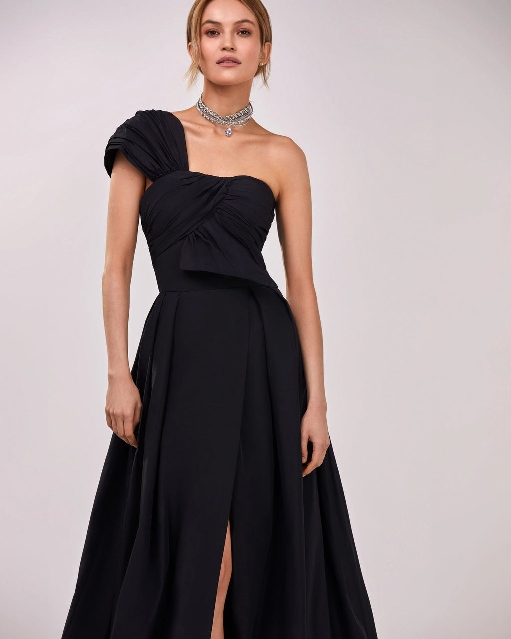 Black taffeta evening gown with a high slit and one shoulder wrap top