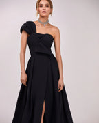 Black taffeta evening gown with a high slit and one shoulder wrap top