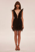 Dramatic cocktail dress on straps decorated with sequins and feathers