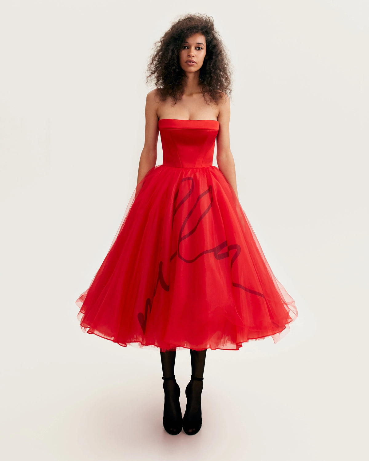 Dramatic red organza dress adorned with Millas signature and black gloves Xo Xo
