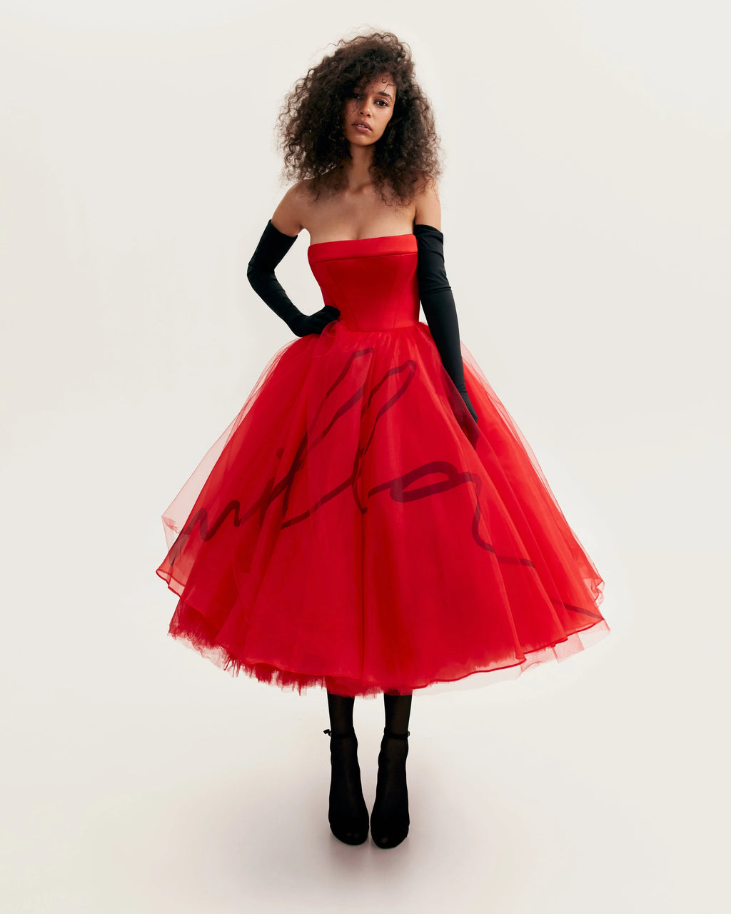 Dramatic red organza dress adorned with Millas signature and black gloves Xo Xo